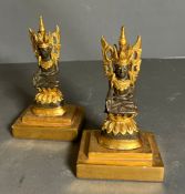 Two Buddha statues on wooden gilt bases