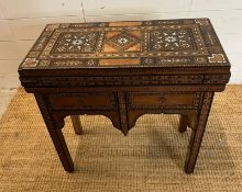 A marquetry inlaid games table with playing surface, back gammon, chess board etc , Damasais or