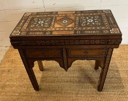 A marquetry inlaid games table with playing surface, back gammon, chess board etc , Damasais or