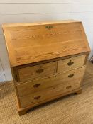 A pine bureau with brass handles and drop down writing slope (H105cm W93cm D47cm)