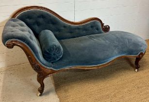 A Victorian blue upholstered chaise longue with button back on a carved mahogany frame (H85cm W190cm