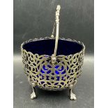 A silver plate pierced sugar bowl with blue glass insert