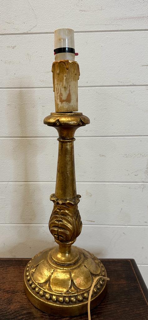 A wooden gold painted table lamp in the Rocco style