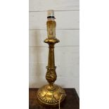 A wooden gold painted table lamp in the Rocco style