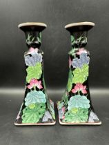 A pair of Mid Century ceramic candle sticks with floral detail