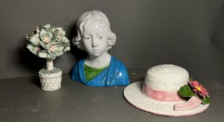 A selection of painted ceramics to include a bust of a lady a summer hat and a tree with birds,