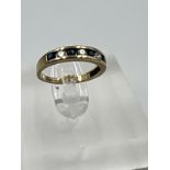 A 9ct gold diamond and sapphire ring, approximate size I.