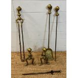 A brass fireside companion set to include fire dogs, shovel and poker with claw and ball detail