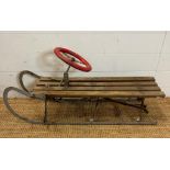 A vintage Rojtos Childs sledge with red steering wheel
