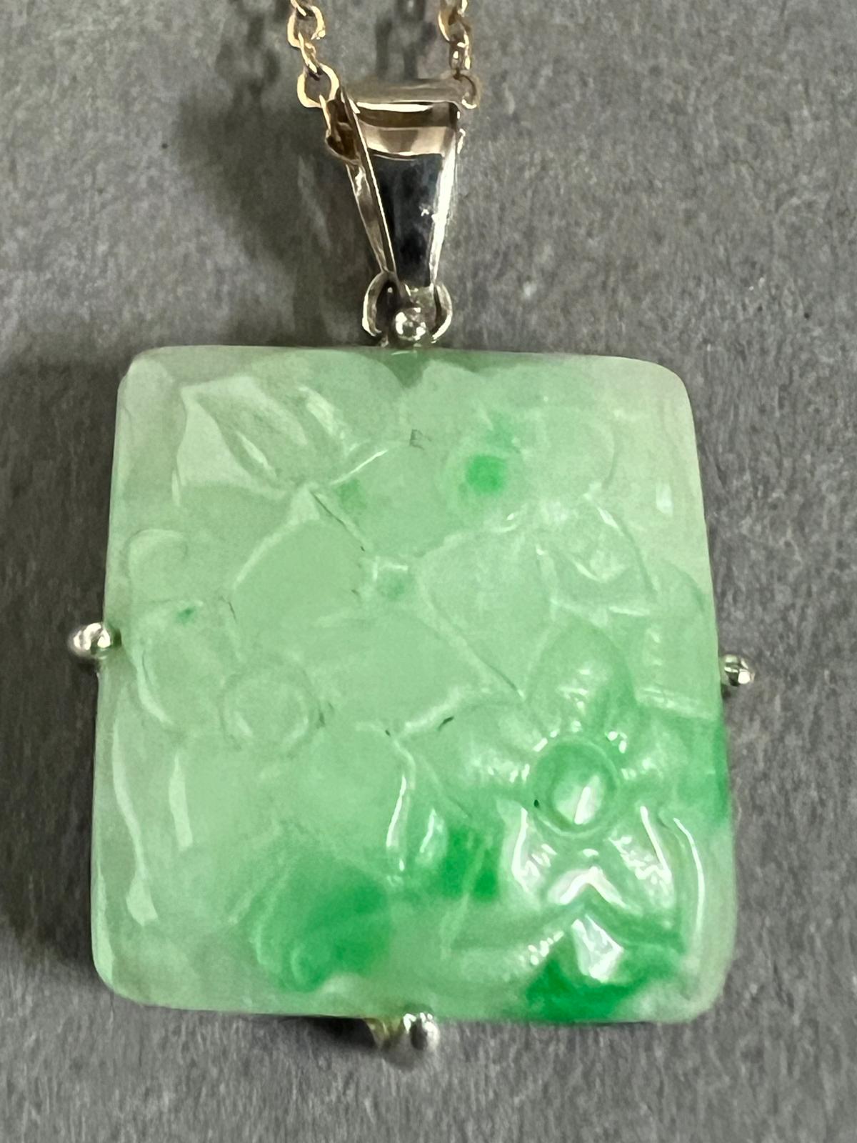 A square jade pendant on a 9ct gold necklace.
