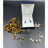 A selection of costume jewellery to include silver earrings etc.