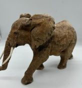 A wooden carved ornamental elephant (H20cm W30cm)