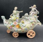 A ceramic ornament of a carriage in the style of Capodimonte