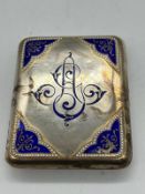 A white metal and enamel cigarette case (7cm x 9cm)