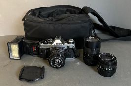 A Canon AE-1 program 35mm camera three lenses, a flash and bag