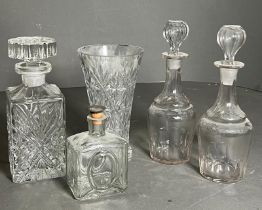 A selection of cut glass decanters and a vase