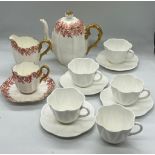 Four Shelley white tea cups and saucers and a Coalport teapot, milk jug and cup and saucer