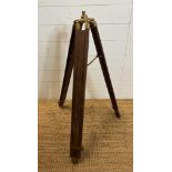 A vintage wooden and brass extendable tripod