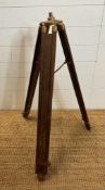 A vintage wooden and brass extendable tripod