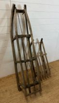 Two vintage Bentwood sledges, one stamped "Davos"