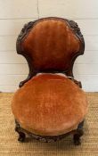 A mahogany framed nursing chair with red velvet upholstery