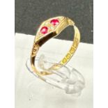 An 18ct gold antique ring with inset rubies and ornate design, approximate total weight 2.1g and