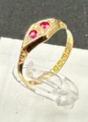 An 18ct gold antique ring with inset rubies and ornate design, approximate total weight 2.1g and