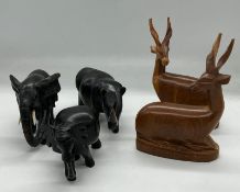 Two teak Antelopes and three carved Elephants