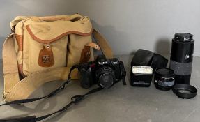 A Minolta Dynax 35mm 7000I camera and lenses in a canvas camera bag