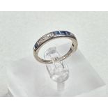 A diamond and sapphire, half eternity style ring set in 18ct white gold, approximate size M