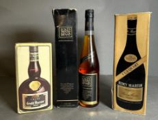 A 1 US Quart bottle of Remy Martin Cognac, A boxed bottle of Creme de Grand Marnier and a bottle