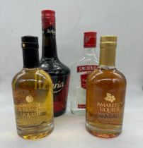 A selection of four bottles of Spirits to include: Tia Maria, Smirnoff Vodka, Amaretto Liqueur and