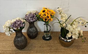 Four faux flowers in contemporary vases