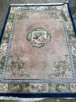 A large Chinese style wool rug/carpet with pink grounds and geometric boarder 390cm x 270cm