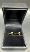 A pair of diamond stud earrings marked 750