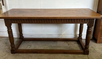 An oak hall table with carved front, on turned legs and block feet (H75cm W169cm x d68cm)