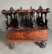 A Victorian carved rosewood Canterbury on turned feet with single drawer under. (53cm x 37cm x
