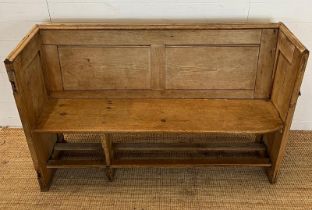 A pine pew with shelf behind (H92cm W143cm D48cm SH48cm)