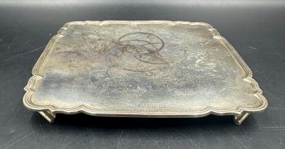 A hallmarked silver tray on four feet, hallmarked for Birmingham by S Blanckensee & Son Ltd 1936,