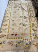 A large embroidery rug with cream grounds and floral stemmed flowers 380cm x 285cm