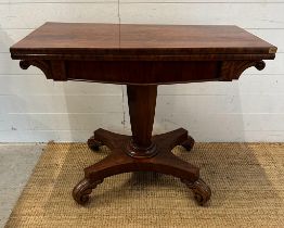 A Regency style mahogany fold over tea table with hexagonal central support terminating on four