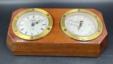 Wempe ships style wall clock and barometer, with circular brass bezels, housed in a shaped