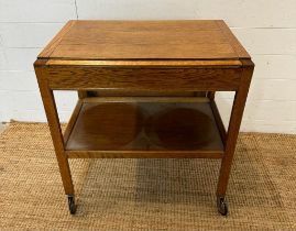 A Mid Century metamorphic tea trolly and table on castors