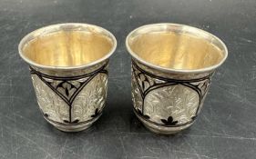 A pair of silver Niello Vodka cups, marked 875 (Total weight 68.3g)