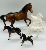 Four Beswick china horses and one alabaster unicorn