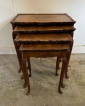 A nest of four bur walnut side tables with crimped tops on splayed feet (H55cm W55cm D37cm)