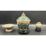 Three Chinese style ceramic items, two lidded jars and a stem dish in the famille rose palette