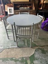 A grey circular extendable dining table and four chairs (Dia110cm)
