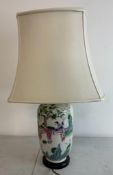 A Japanese ceramic vase table lamp decorated with Geisha girls and cherry blossom trees