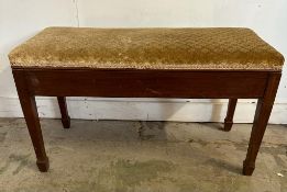 A Mid Century mahogany flamed piano bench with hinged seat opening to storage (H51cm W90cm D38cm)